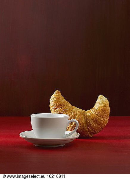 Croissant and coffee cup  close up