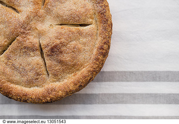 Cropped image of apple pie on table