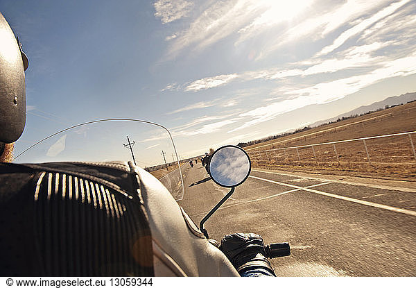 Cropped image of biker on road