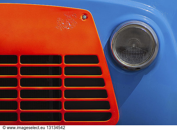 Cropped image of blue vintage car with orange grille