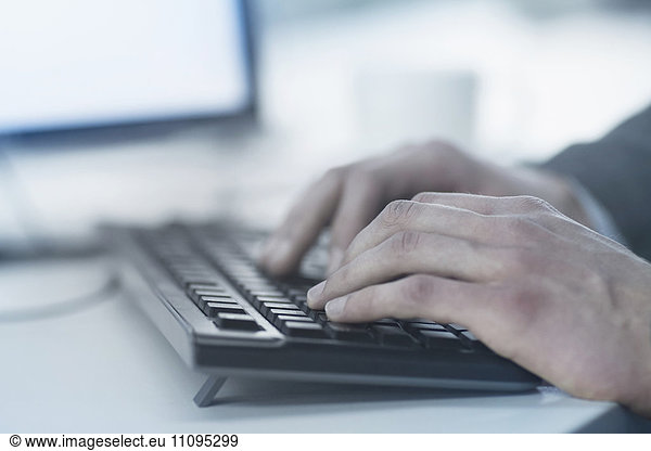 Cropped image of business person typing on computer keyboard  Freiburg im Breisgau  Baden-Württemberg  Germany