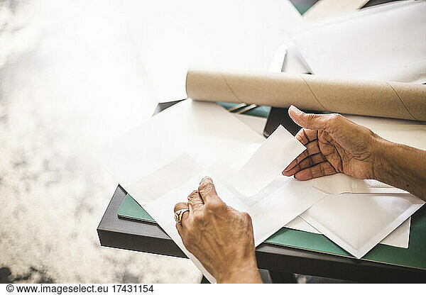 Cropped image of craftswoman labeling envelope