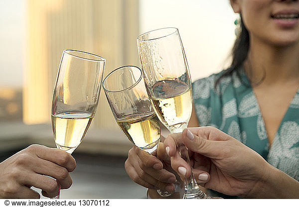 Cropped image of hands toasting champagne flutes