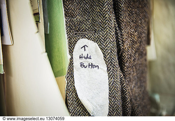 Cropped image of jacket with text on clothes rack