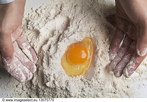 Cropped image of man preparing dough