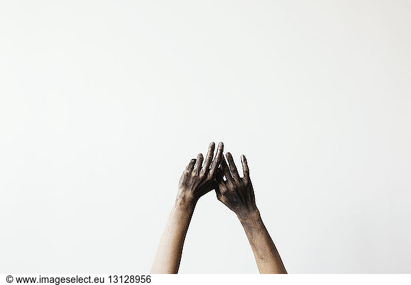 Cropped image of messy hands against white background