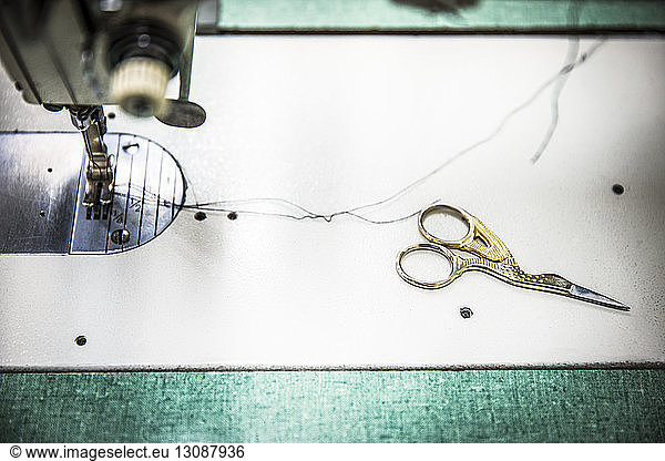 Cropped image of sewing machine with scissors