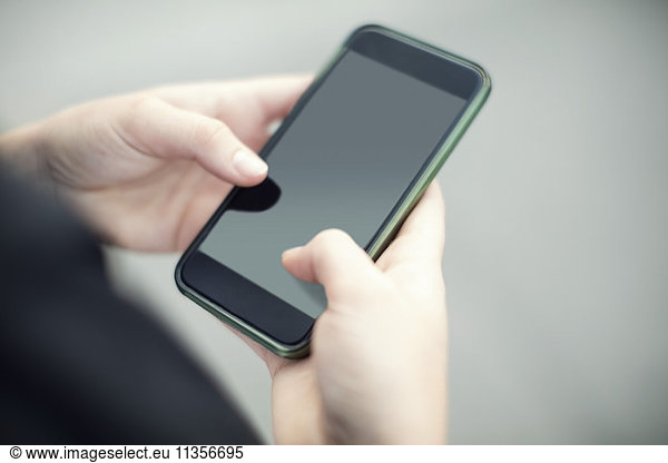 Cropped image of woman using smart phone