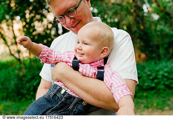 Cropped portrait of a father holding his baby boy