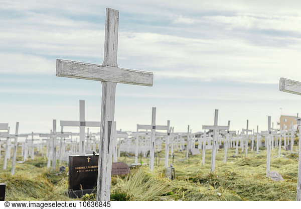 Crosses at cemetery against sky