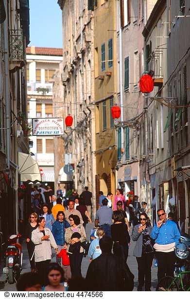 Crowd of people walking  talking  eating ice cream on Italian street