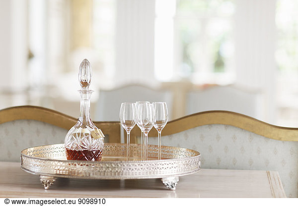Crystal sherry decanter and cordial glasses on silver tray