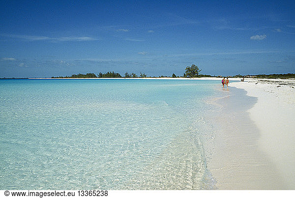 CUBA Isla De Juventud Cayo Largo Playa Sirena with couple of tourists walking by the waters edge