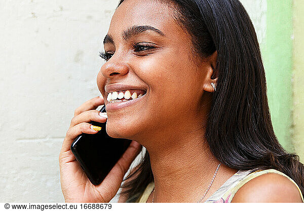 cuban young woman talking on the phone