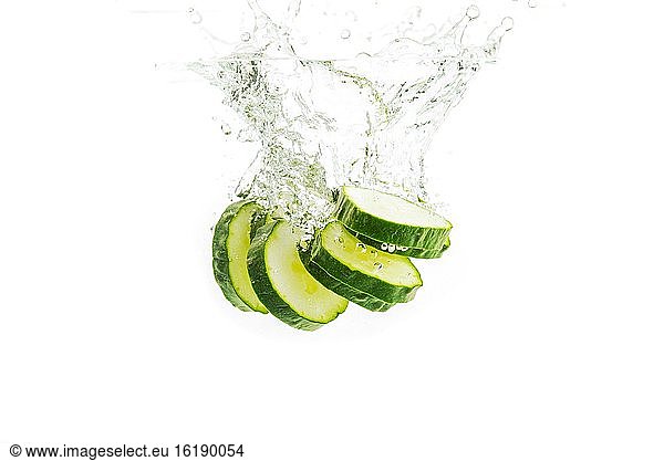 Cucumber in slices falls into the water  studio shot  cutout  Austria  Europe