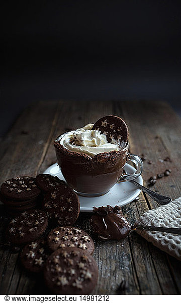 Cup of chocolate pudding with cream  chocolate cookies