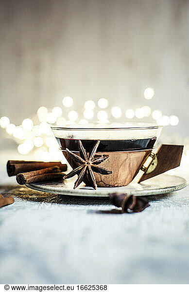 Cup of mulled wine with cinnamon sticks and star anise