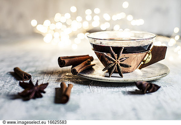 Cup of mulled wine with cinnamon sticks and star anise