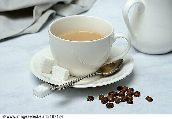Cup with latte and coffee beans