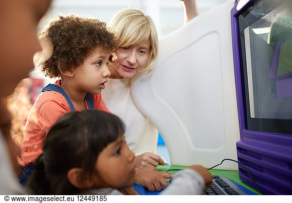 Curious kids using computer in science center