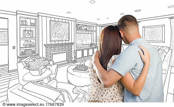 Curious young military couple looking over custom living room design drawing