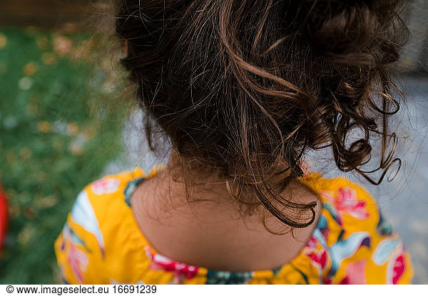 Curly hair little girl outside