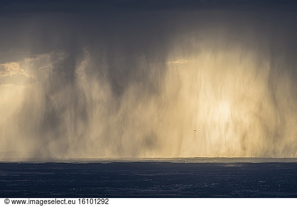 Curtain of stormy rains at sunset  on the plateau of Ain  France