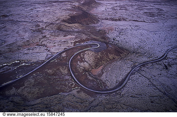 Curvy freeway among desert stony terrain