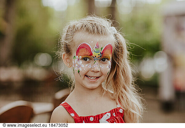 Cute blond girl with face painting