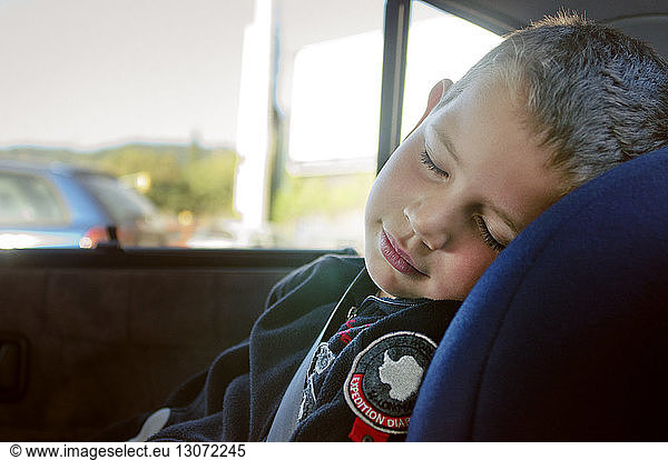 Cute boy sleeping in car