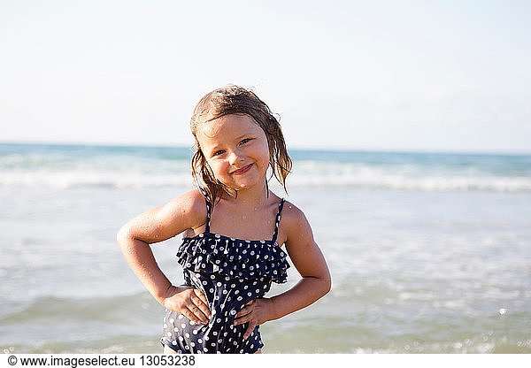 Cute girl on beach in spotted swimming costume  portrait  Castellammare del Golfo  Sicily  Italy