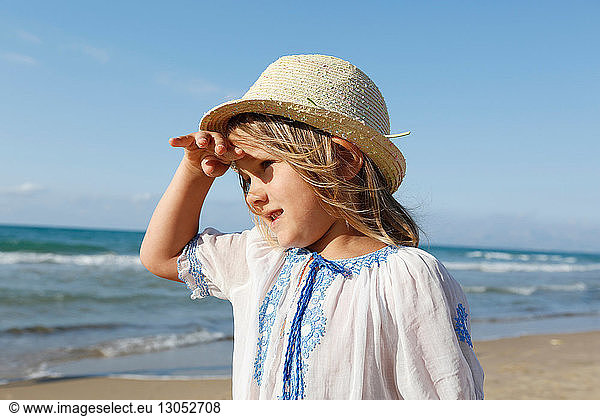 Cute girl on beach shielding her eyes  Castellammare del Golfo  Sicily  Italy