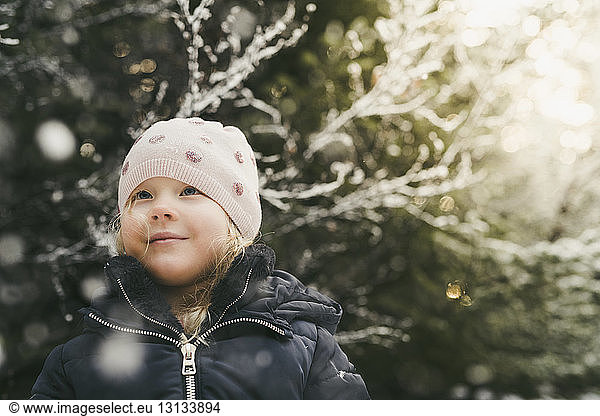 Cute girl wearing warm clothing while looking away