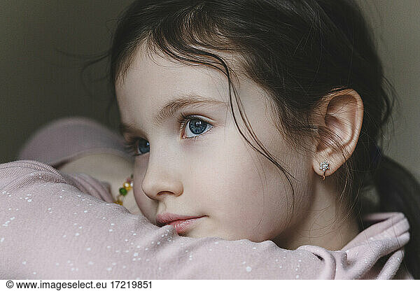 Cute girl with blue eyes looking away