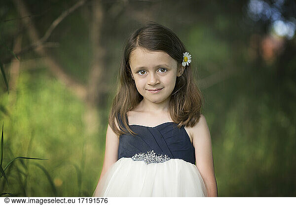 Cute little girl in white dress outdoors.