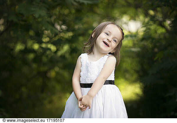 Cute little girl toddler laughing outdoors.
