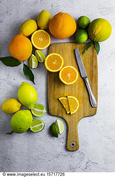 Cutting board  kitchen knife and various citrus fruits