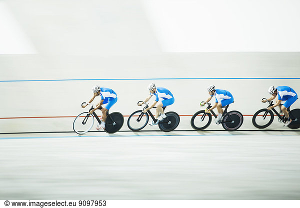Cyclists racing around velodrome