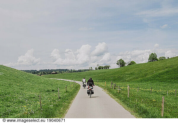 Cyclists ride in a green landscape in Germany