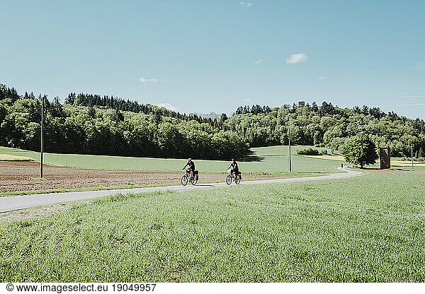 Cyclists riding his bikes in a big meadow in Germany