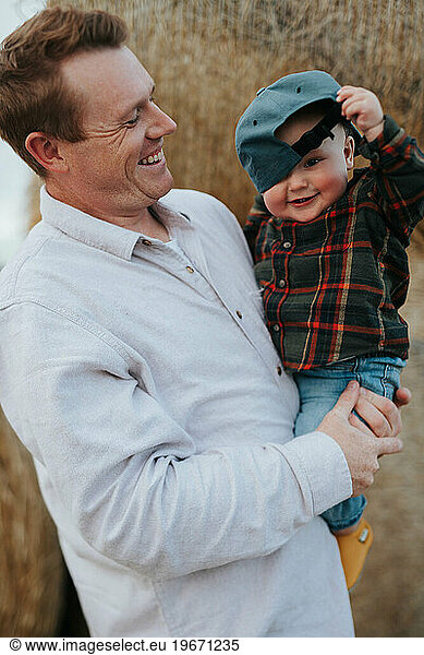 Dad and son hanging out at the pumpkin patch