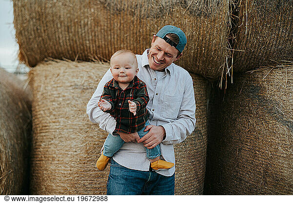 Dad and son hanging out at the pumpkin patch