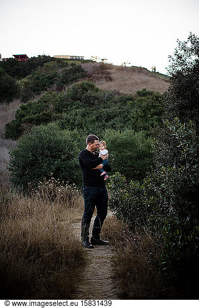 Dad Holding Infant Daughter