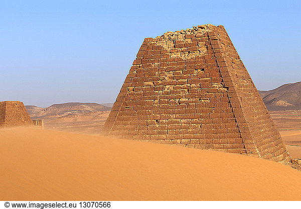 Damaged Pyramid against sky