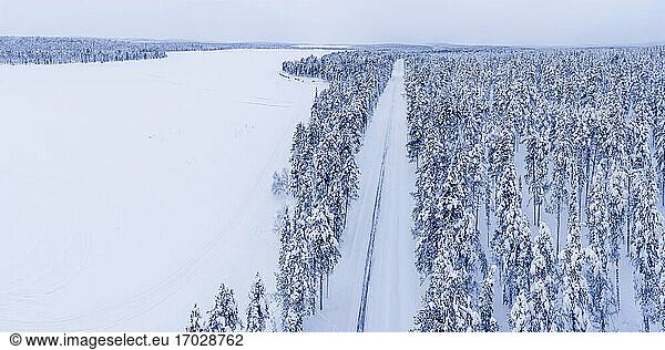 Dangerous road conditions of icy snow covered winter road in the Arctic Circle in Lapland  Finland drone