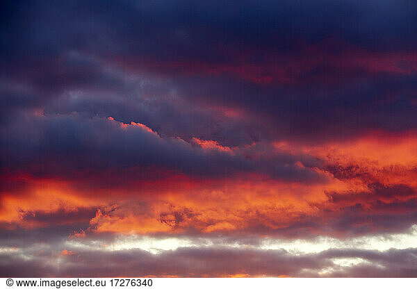 Dark clouds illuminated by setting sun