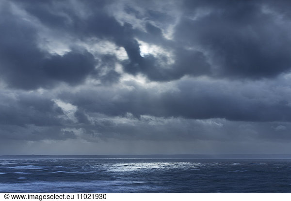 Dark clouds in overcast sky over ocean  Devon  United Kingdom