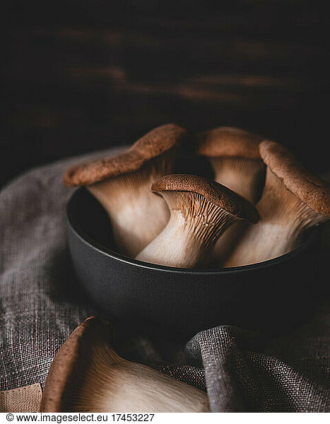 dark grey bowl full of king trumpet mushrooms