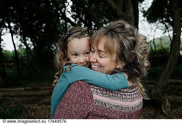 daughter hugging mother tightly lovingly