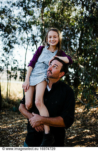 Daughter Posing on Dad's Shoulder at Park in Chula Vista